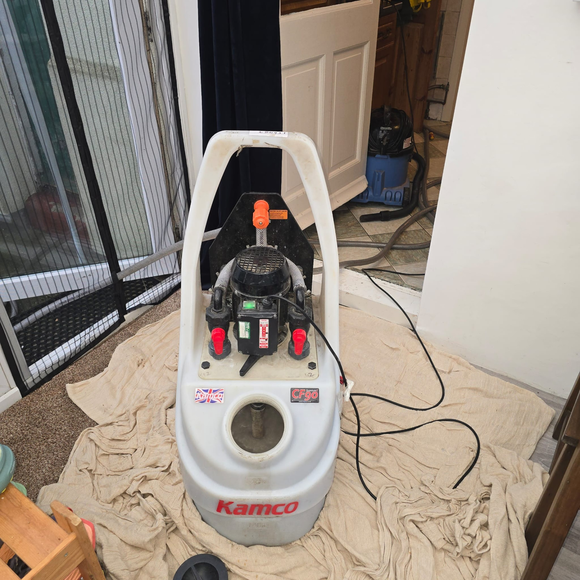 Kamco power flushing pump connected on protective sheeting during a central heating power flush