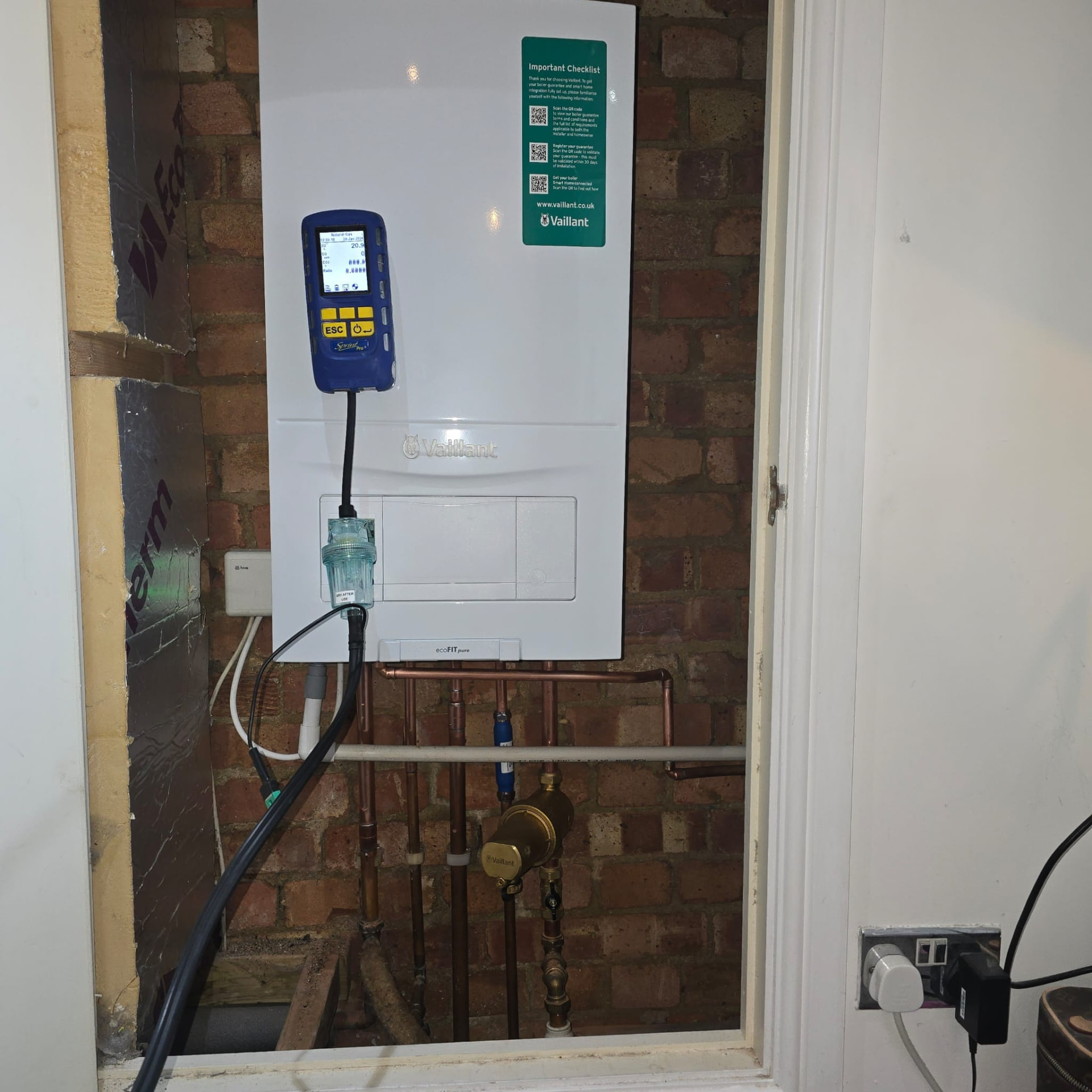 Flue gas analyser connected to a Vaillant boiler during an annual boiler service in Essex